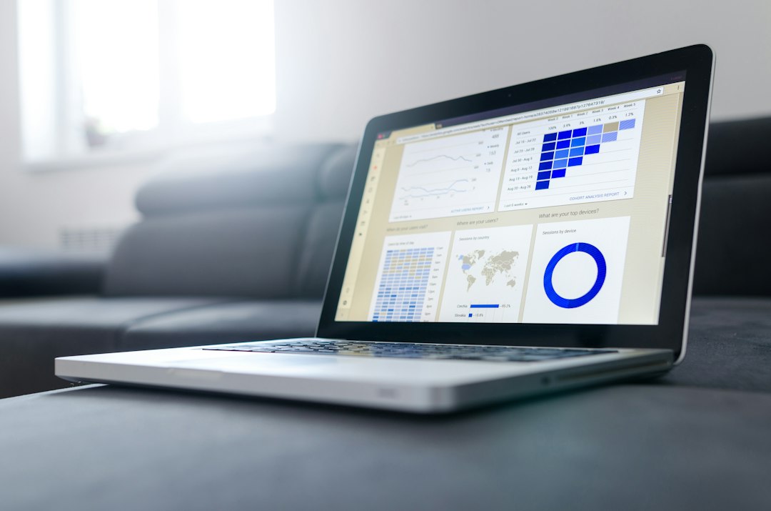 Laptop and notebook showing data and statistics used in automated valuation